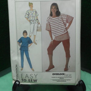 May include: Simplicity sewing pattern number 9207 for sizes MD-XXL. The pattern includes instructions for making a top and trousers. The pattern is labelled "Easy to Sew" and is suitable for use with an overlock/serger machine.