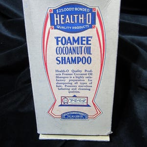 May include: A vintage rectangular cardboard box for Health-O Foamee Cocoanut Oil Shampoo. The off-white box features blue and red typography, including the text $25,000 Bonded, Health-O Quality Products, and The Milson Co. Cincinnati, Ohio, U.S.A.