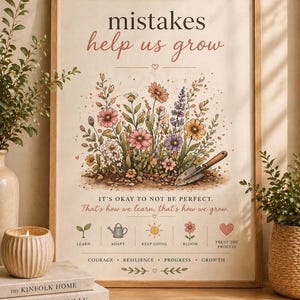 May include: A framed print with the words "mistakes help us grow" in pink and black. The artwork features a colorful floral arrangement with a trowel. Below the text are icons and phrases like "Learn", "Adapt", and "Bloom".