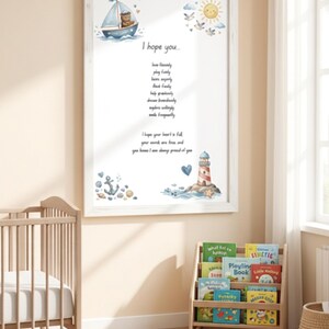 May include: A white framed wall art print featuring a nautical theme with a bear in a sailboat, a lighthouse, an anchor, and a sun. The text reads: I hope you... love fondly, play fairly, been enjoyly, think freely, help graciously, dream boundlessly, explore daringly, smile frequently. I hope your heart is full, your words are true, and you know I am always proud of you.