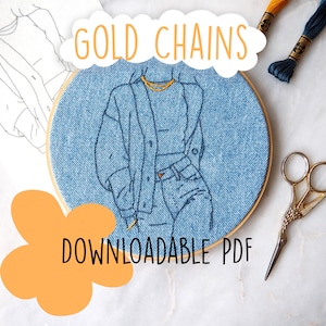 May include: An embroidery hoop with a denim-textured fabric features a stitched outline of a person in a denim jacket and jeans, wearing a gold chain. The text "GOLD CHAINS" and "DOWNLOADABLE PDF" are also visible. Gold scissors and embroidery thread are in the background.