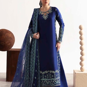 May include: A navy blue dress with detailed embroidery and a matching shawl. The dress has long sleeves and is embellished with intricate beadwork around the neckline and cuffs. The design is elegant and suitable for formal events. The dress is approximately 150 cm in length.