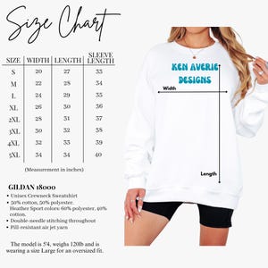 May include: A white crewneck sweatshirt featuring the text Ken Averie Designs in blue. The image includes a size chart with measurements in inches for sizes S through 5XL, detailing width, length, and sleeve length for the Gildan 18000 unisex garment.