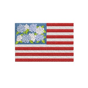 May include: Embroidered American flag design featuring red and white stripes and a blue field. The blue field is filled with a cluster of white and blue hydrangea flowers with green leaves. The design is stitched with a textured thread.