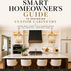 May include: A book cover titled The Smart Homeowner's Guide to Designing Custom Cabinetry by Jac Michelle Designs. The cover features a kitchen with white cabinets, a black range hood, a marble island, and gold pendant lights with text below.