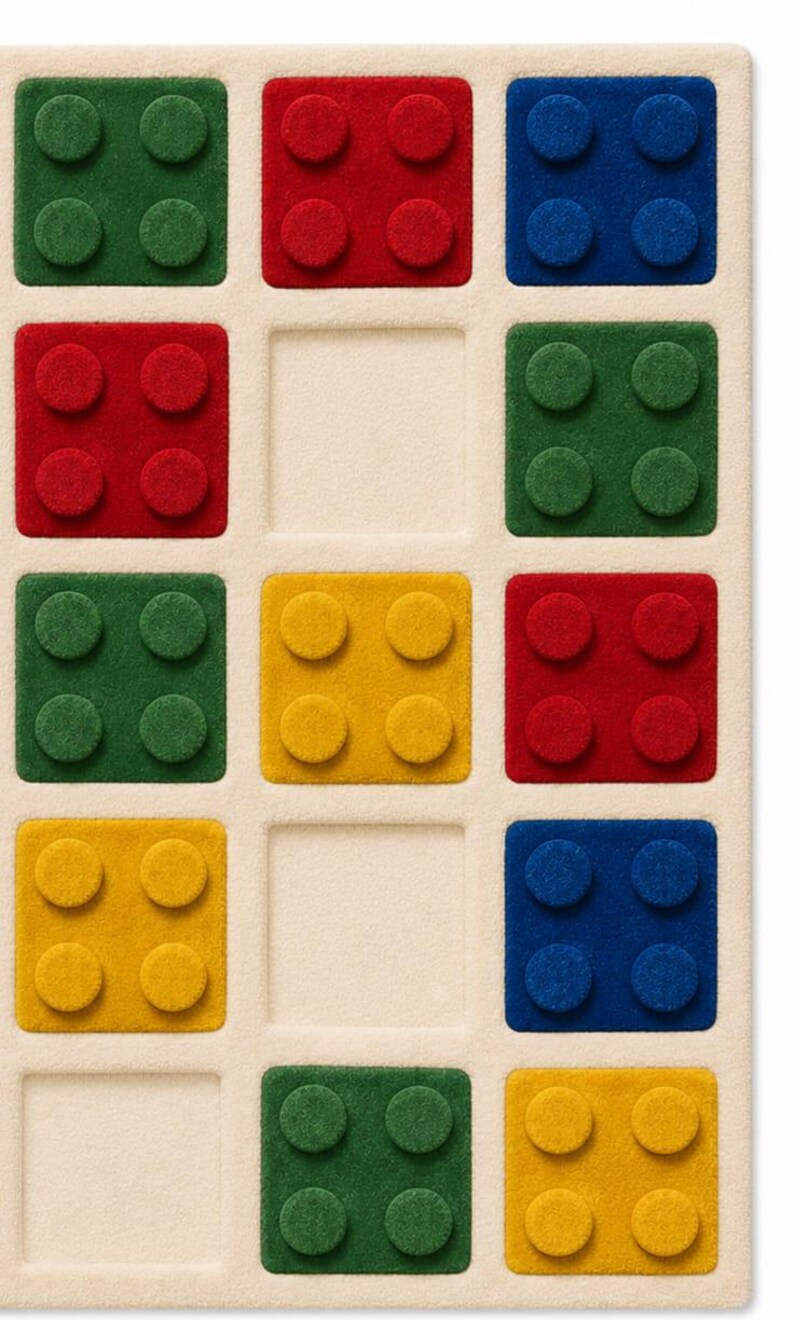 May include: A rectangular beige rug featuring a grid of square cutouts. Some squares contain raised, textured block shapes in red, blue, green, and yellow, each with four circular studs. Other squares are empty, showing the flat beige base.