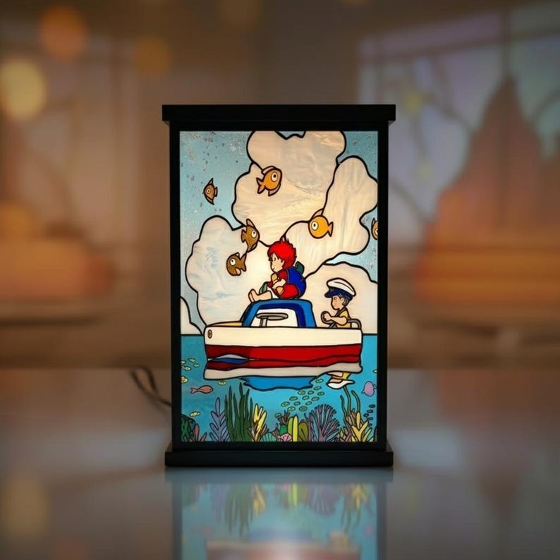 May include: A decorative stained glass lamp featuring a nautical scene. The lamp depicts two figures in a red and white boat, surrounded by fish and clouds. The base and frame are black, and the background is a light blue.