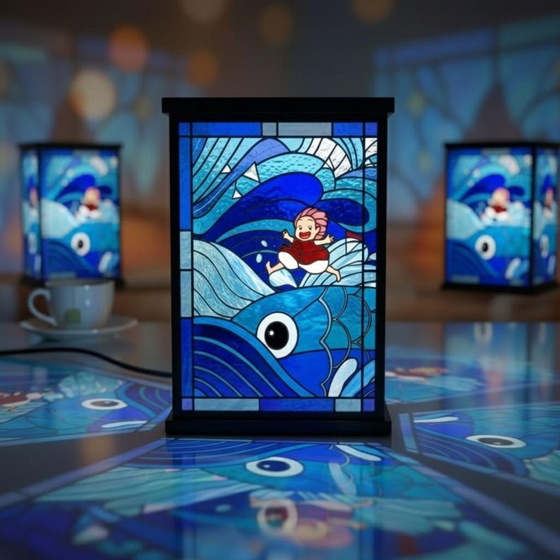 May include: A stained glass lamp with a black frame, featuring a vibrant blue ocean scene with a running figure and a large fish. The lamp is illuminated, with two similar lamps in the background. The scene is reminiscent of a popular animated film.