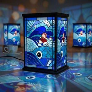 May include: A stained glass lamp with a black frame, featuring a vibrant blue ocean scene with a running figure. The lamp's design includes stylized waves and a fish with a large eye. Additional lamps are visible in the background.