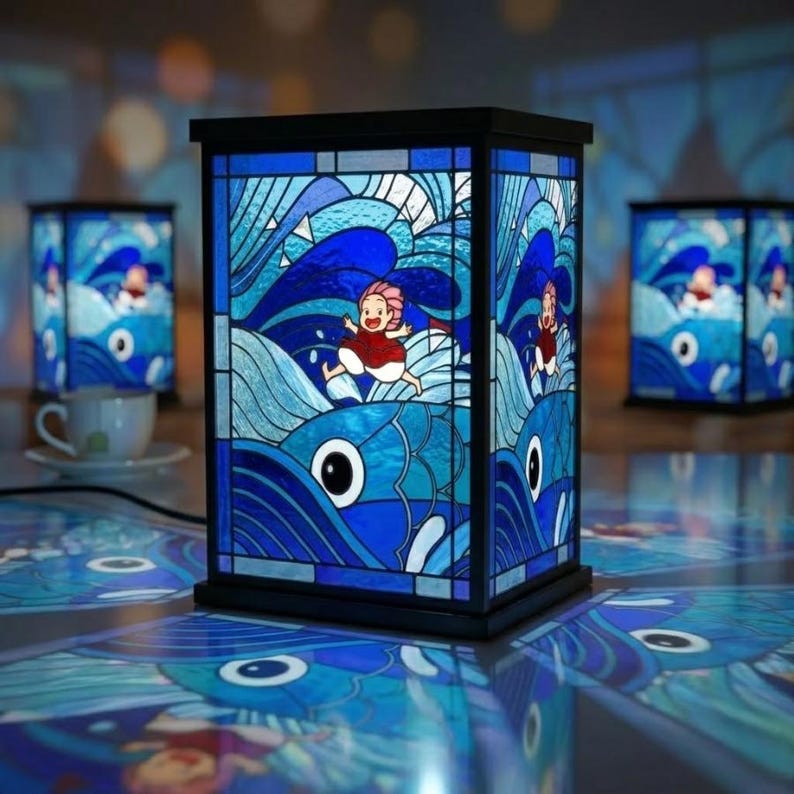 May include: A stained glass lamp with a black frame, featuring a vibrant blue ocean scene with a running figure. The lamp's design includes stylized waves and a fish with a large eye. Additional lamps are visible in the background.