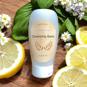 May include: A light blue bottle of "Cleansing Balm" with a beige label featuring the brand name "BOTAVAL" and botanical illustrations. The bottle is surrounded by lemon slices, white flowers, and green leaves. The bottle contains N.W. 5 oz.