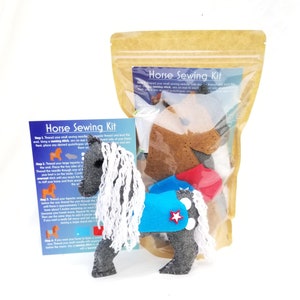 May include: A horse sewing kit with felt pieces in a clear plastic bag. The kit includes a gray horse with a blue and red saddle, a white mane, and a red star. The instructions are printed on a card that says "Horse Sewing Kit".