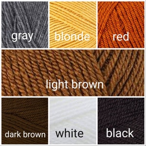 May include: A collection of yarn skeins in various colors, including gray, blonde, red, light brown, dark brown, white, and black.