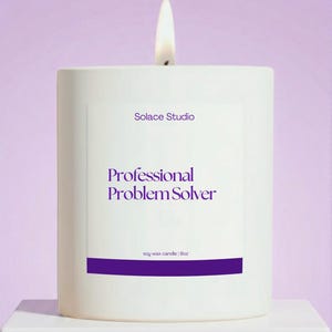 May include: A lit white soy wax candle with the text "Professional Problem Solver" in purple. The candle is from Solace Studio and is 9oz. The background is a soft purple.