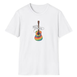 May include: White t-shirt featuring a colorful tie-dye guitar graphic with the text "Billy Strings" in a script font. The guitar design incorporates shades of blue, green, yellow, and red. The shirt is a classic crew neck style.