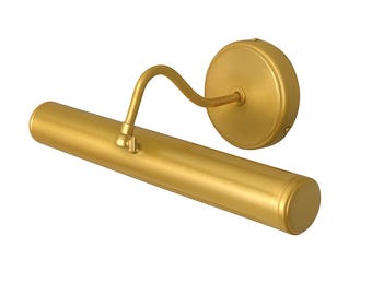 May include: A gold-colored picture light with a cylindrical light fixture and a curved arm. The light is attached to a round wall mount. The fixture is made of metal and has a smooth, reflective surface. The overall design is simple and elegant.