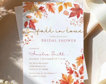 May include: A white bridal shower invitation card featuring watercolor autumn leaves in shades of red, orange, and yellow. The text reads fall in love, PLEASE JOIN US FOR A BRIDAL SHOWER, IN HONOR OF Amelia Smith, and event details.