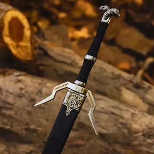 May include: A sword with a black handle and a silver-colored pommel shaped like a wolf head. The crossguard features intricate silver-colored metalwork with engraved details and two downward-curving quillons extending from the central hilt.