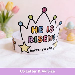 May include: A white paper crown with the text "HE IS RISEN!" in colorful letters. The crown has a cross and stars, with the Bible verse Matthew 28:6. Perfect for Easter celebrations.