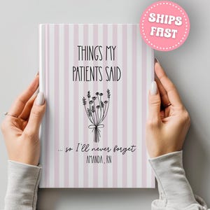 May include: A notebook with a pink and white striped cover, held by hands. The cover reads "THINGS MY PATIENTS SAID" with a floral illustration and the text "...so I'll never forget AMANDA, RN."