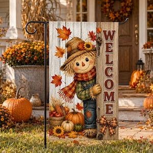 May include: A rectangular garden flag featuring a scarecrow wearing a straw hat and plaid scarf, peeking from behind a wooden board with the word WELCOME printed vertically in brown letters, decorated with autumn leaves and pumpkins.
