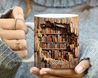 May include: White ceramic mug featuring a 3D bookshelf design with a wooden exterior. The bookshelf is filled with various books in shades of brown and red. The name "Sophia" is printed on the front of the mug.
