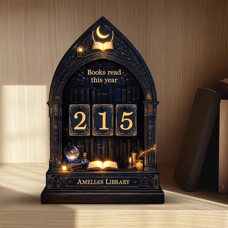 May include: A dark blue wooden bookshelf with a gothic arch design. The bookshelf displays the text "Books read this year" and the number "215" in gold. The bottom of the shelf reads "Amelia's Library".