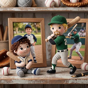May include: Two handmade crochet baseball player dolls. One doll sits wearing a blue cap and pinstripe uniform holding a bat. The other doll stands wearing a green cap and green jersey with the number 24, holding a bat over its shoulder.