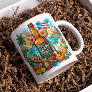 May include: A white ceramic mug featuring a colorful tropical illustration of a beer bottle labeled Island Vibes, a Puerto Rican flag, a guitar, a frog, a wooden barrel, pineapple, watermelon, lime, and a coastal landscape scene.