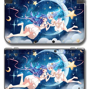 May include: A Nintendo 3DS console skin featuring a celestial anime design. The skin showcases two anime girls floating in a starry night sky with a crescent moon and stars. The color palette includes blues, whites, and pinks.