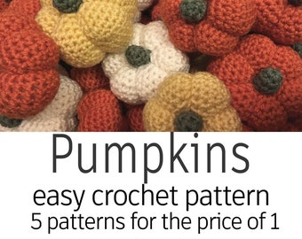 May include: A collection of crocheted pumpkins in various sizes and colours, including orange, yellow, and white. The pumpkins are arranged in a pile, with some overlapping. The image includes the text "Pumpkins easy crochet pattern 5 patterns for the price of 1 www.etsy.com/shop/LydiaandKims".