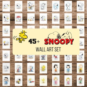May include: A collection of Snoopy wall art prints arranged on a wooden background. The prints feature various Snoopy illustrations, with the text "45+ Snoopy Wall Art Set" in the center. The artwork includes Snoopy and Woodstock.