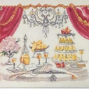 Può includere: Un ricamo a punto croce che raffigura una tavola formale incorniciata da tende rosse e colonne dorate. La scena presenta un'alzata per dolci a più piani con pasticcini gialli, un lampadario di cristallo, fiori rosa, calici e una busta.