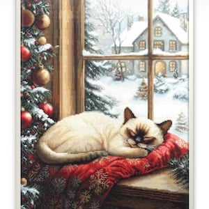 Könnte beinhalten: Eine winterliche Szene mit einer schlafenden Siamkatze auf einem roten Kissen am Fenster. Das Fenster blickt auf eine verschneite Landschaft mit einem Haus und einem Weihnachtsbaum. Christbaumschmuck und ein Weihnachtsbaum sind zu sehen.