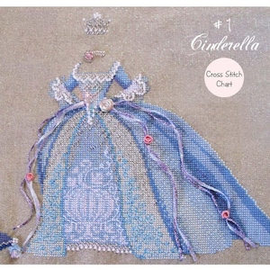 May include: A cross stitch chart titled #1 Cinderella featuring a blue ball gown with intricate white detailing, a small crown, and a matching blue accessory. The design includes ribbons and small pink floral accents on a light tan fabric background.