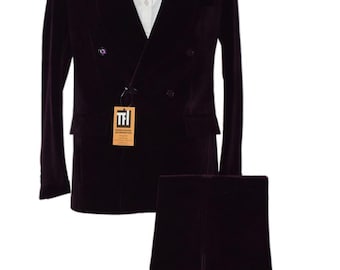 May include: A formal, double-breasted burgundy velvet suit with a matching pair of trousers. The suit features a white dress shirt, a black bow tie, and a white pocket square. A tag with text hangs from the jacket.
