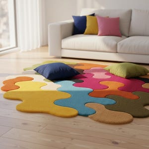 May include: An area rug featuring an irregular, organic shape composed of interlocking, puzzle-like sections in vibrant colors including yellow, orange, blue, pink, and olive green, with a textured, tufted surface finish.