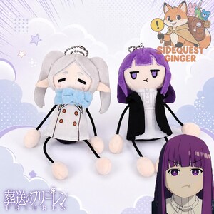 May include: Two plush dolls featuring characters from Frieren: Beyond Journey's End. One doll has silver hair and a white coat with a blue scarf, while the other has purple hair and a black coat. Both have thin limbs and metal ball chains for hanging.