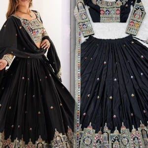 May include: A black traditional Indian dress with detailed, multi-coloured embroidery. The outfit comprises a long skirt, a cropped top, and a matching scarf. The embroidery showcases intricate patterns and embellishments.