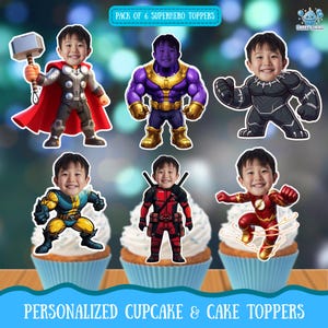 May include: Six superhero-themed cupcake toppers featuring a child's face, each in a different costume: Thor, Thanos, Black Panther, Wolverine, Deadpool, and The Flash. The toppers are on cupcakes with blue liners and white frosting. Text reads "PACK OF 6 SUPERHERO TOPPERS" and "PERSONALIZED CUPCAKE & CAKE TOPPERS."