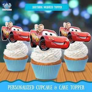 May include: Three cupcakes with white frosting and blue sprinkles, topped with Lightning McQueen car toppers featuring a baby's face. The image includes text that reads "Lightning McQueen Topper" and "Personalized Cupcake & Cake Topper."