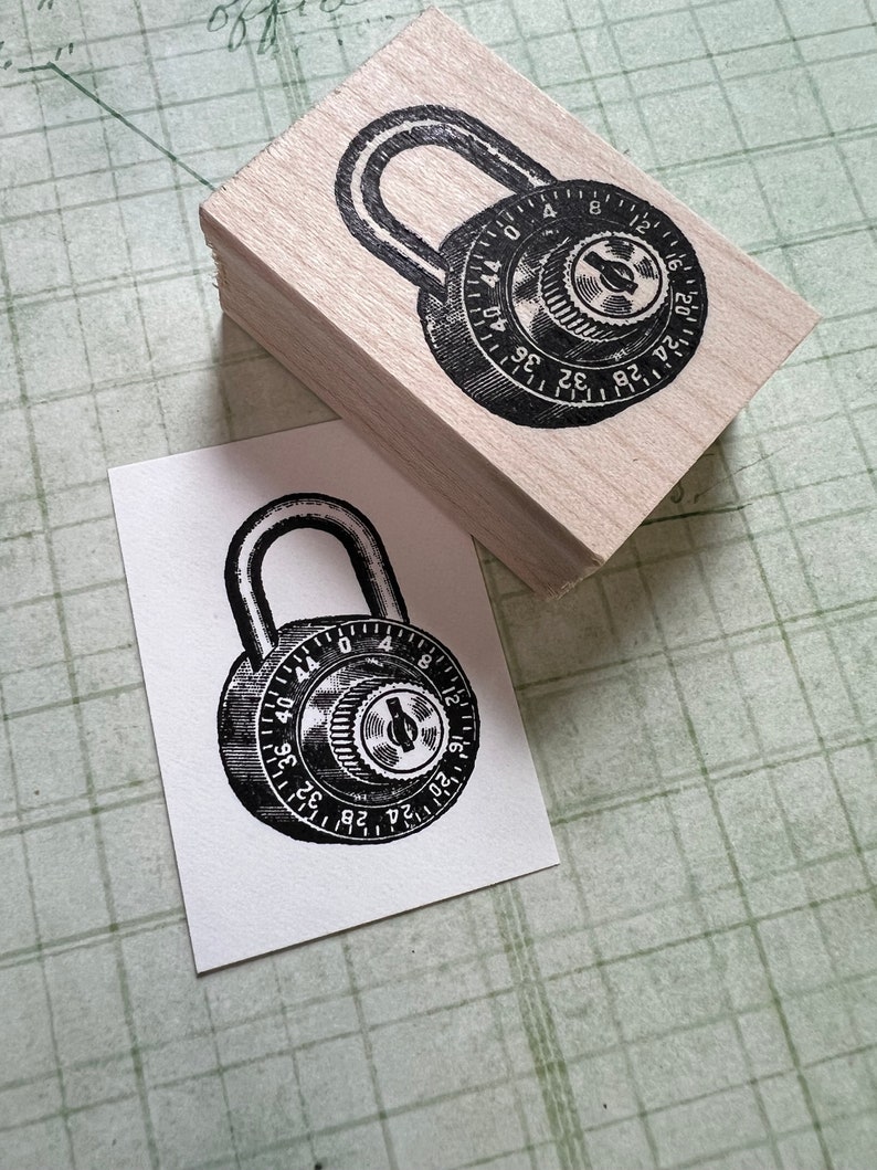 May include: A black and white illustration of a combination padlock with a dial numbered 0 to 44. The padlock is on a wooden block.