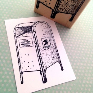 May include: Black and white illustration of a mailbox with a US Mail logo and a dotted pattern. The image is printed on a white card.