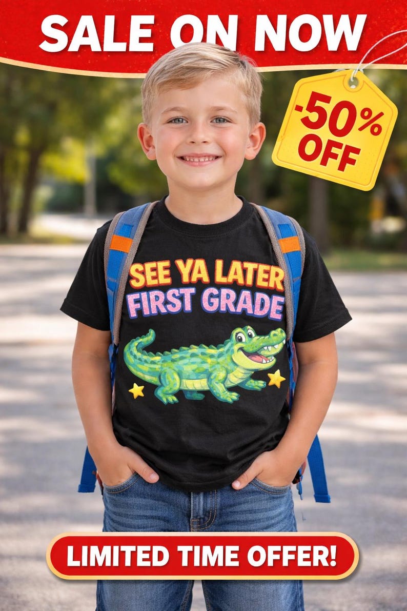 May include: A young boy wearing a black t-shirt with the text "SEE YA LATER FIRST GRADE" and a cartoon alligator graphic. He is wearing a backpack and smiling. A yellow tag reads "-50% OFF".
