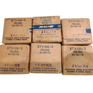May include: A collection of six vintage cardboard boxes, each labeled with Cyrillic text and measurements of 30x55x13. The boxes are beige with blue and black text, and some have dates printed on them. The boxes appear to be old.