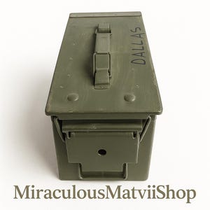 May include: An olive green metal ammunition box with a hinged lid and a handle. The word "DALLAS" is stencilled in black on the top. The box has a latch closure on the front. The shop name "MiraculousMatviiShop" is at the bottom.