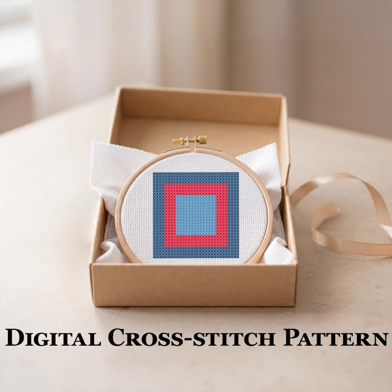 May include: A cross-stitch pattern featuring a geometric design of nested squares in blue and red, set within a wooden embroidery hoop. The hoop is presented in an open cardboard box, with the text "DIGITAL CROSS-STITCH PATTERN" below.