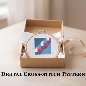 Peut inclure: Un motif de point de croix dans un cercle en bois, avec un design g&eacute;om&eacute;trique bleu, rouge et blanc, est pr&eacute;sent&eacute; dans une bo&icirc;te en carton marron. Le texte "DIGITAL CROSS-STITCH PATTERN" est affich&eacute; en dessous.