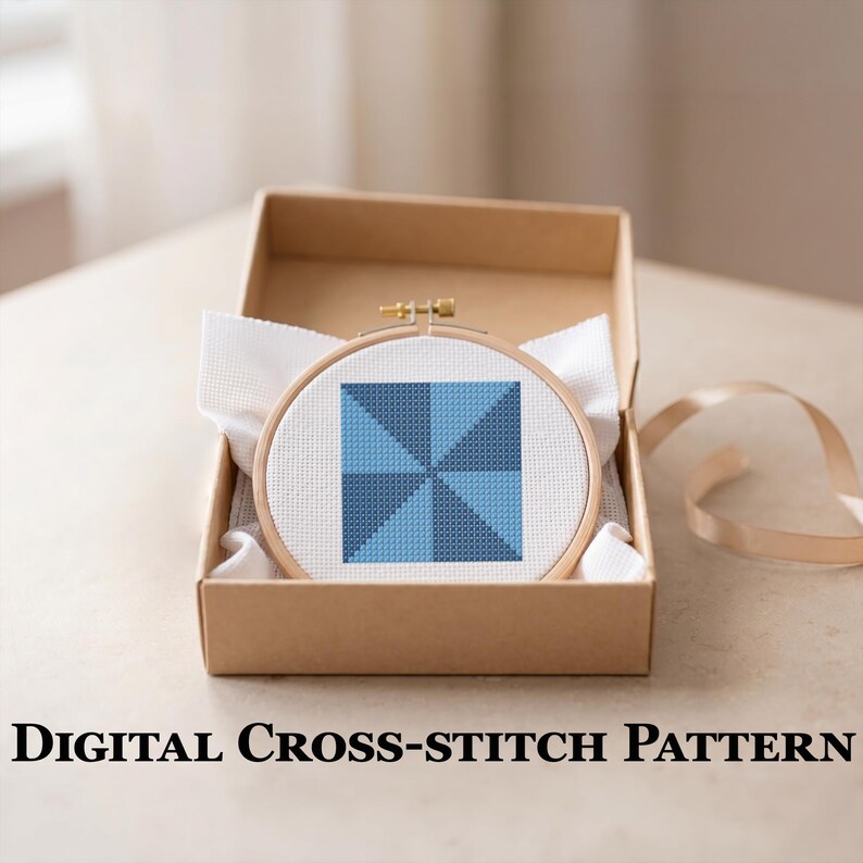 Peut inclure: Un motif de point de croix dans un cercle en bois, avec un motif g&eacute;om&eacute;trique dans des tons de bleu. La broderie est pr&eacute;sent&eacute;e dans une bo&icirc;te en carton marron avec du tissu blanc. Le texte "DIGITAL CROSS-STITCH PATTERN" est affich&eacute; en dessous.