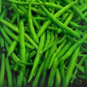 May include: A close-up shot of a pile of fresh, vibrant green string beans. The beans are long, slender, and have a slightly curved shape. They are densely packed together, creating a textured and visually appealing arrangement. The overall impression is one of freshness and natural abundance.